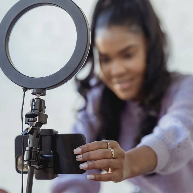 Photo of someone using a selfie stand and ring light