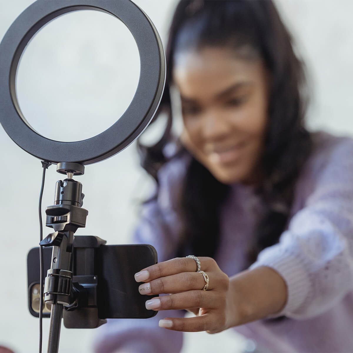 Photo of someone using a selfie stand and ring light