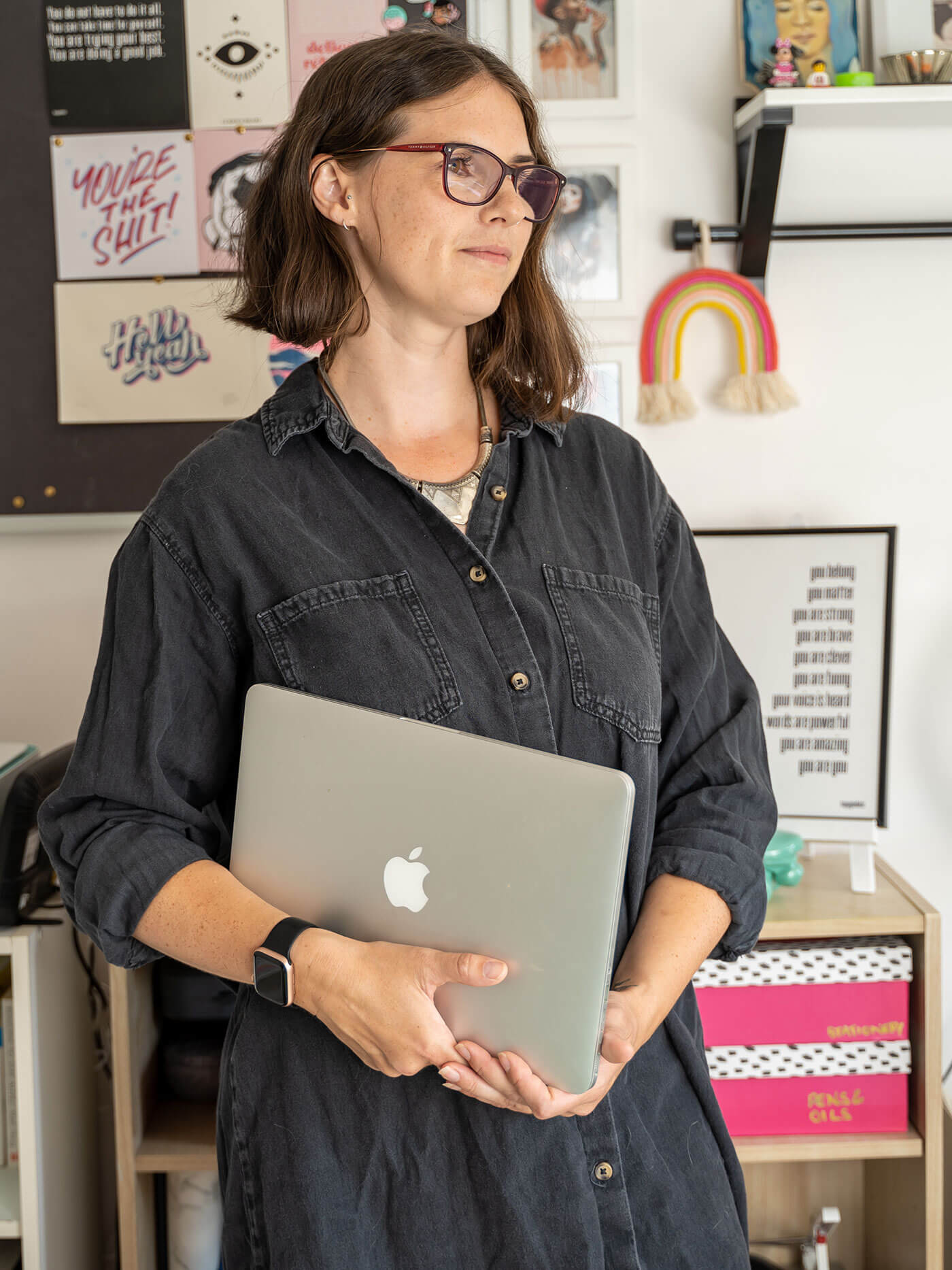 Kirsty McGill designer at Elm Leaf Studio holding laptop