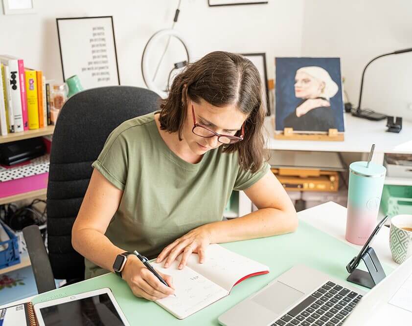 Kirsty McGill designer at Elm Leaf Studio sketching logos in sketchbook